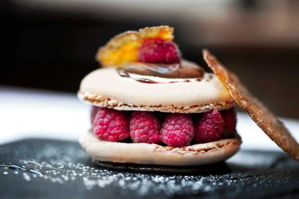 French macarons filled with raspberry and cream for pastry and dairy products