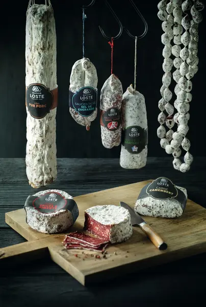 Hanging cured meats and sausages in a traditional charcuterie style