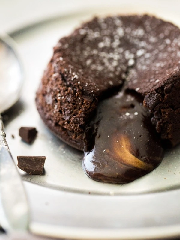 Decadent chocolate lava cake with a molten center on white plate