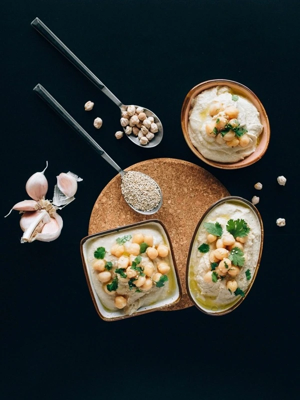 Assorted gourmet dishes and ingredients styled on a dark background